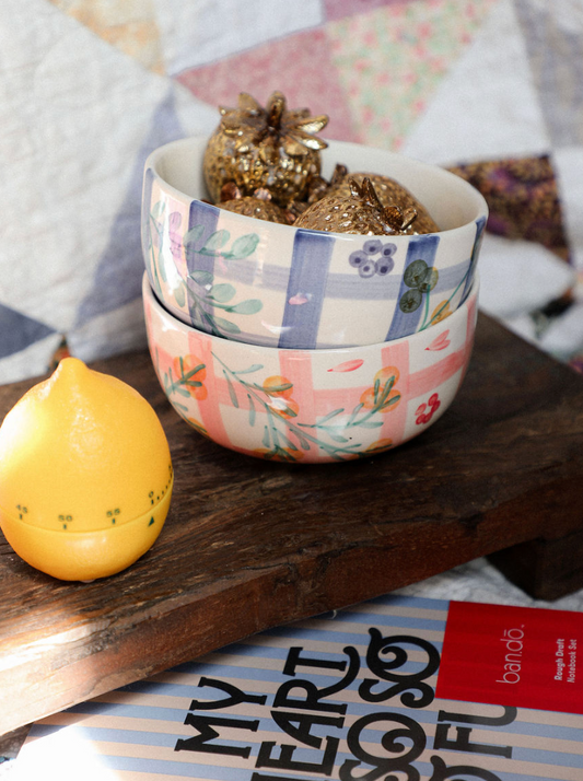 Decorative bowl with floral pattern on a wooden surface