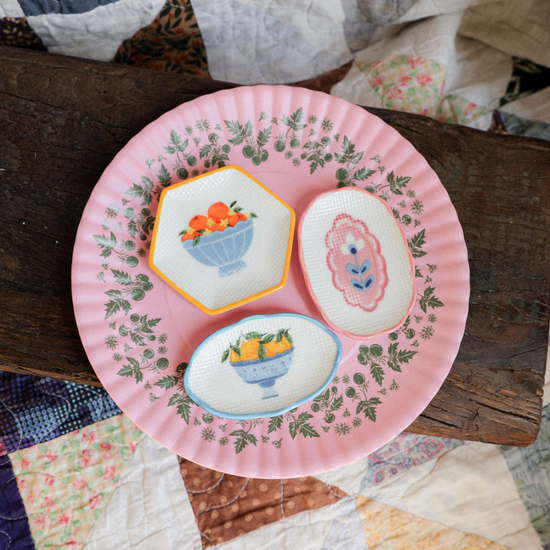 Decorative plate with embroidered designs on a quilted surface