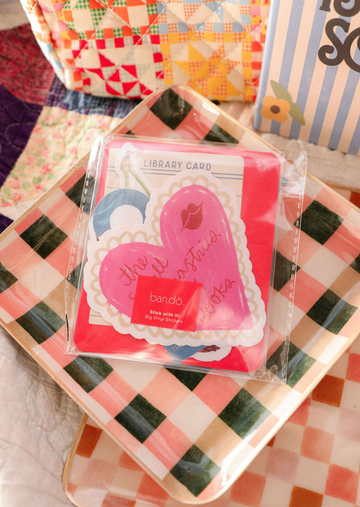 Packaged stickers with heart design on a checkered surface