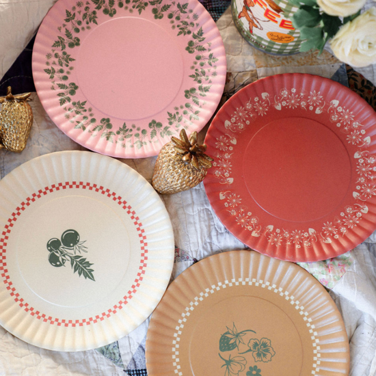 Set of decorative  plates with floral and geometric patterns on a tablecloth.