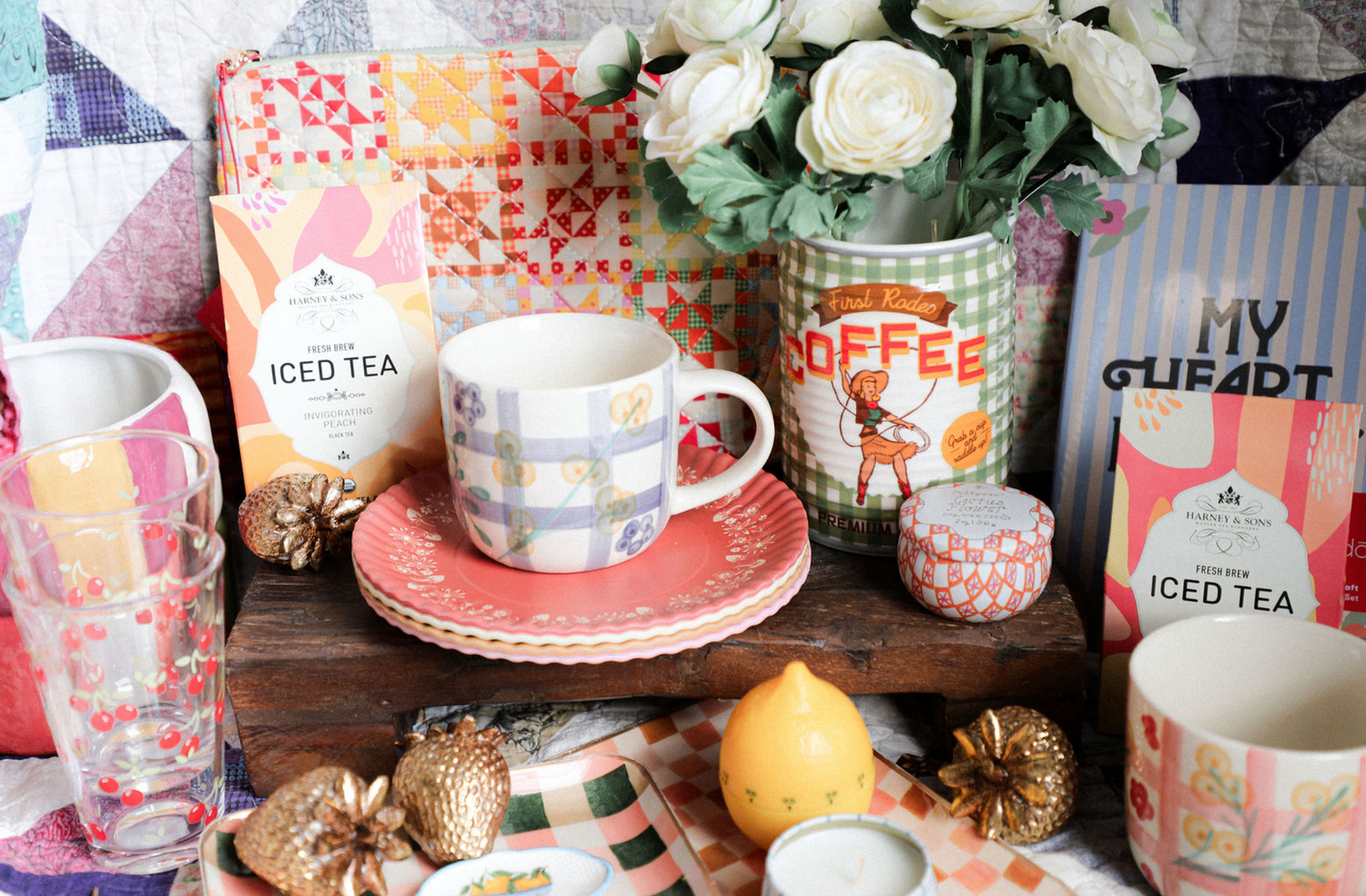 Tea and coffee-themed decor items including mugs, a teapot, and decorative elements on a wooden surface.
