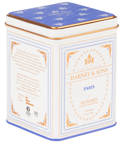 Tea tin by Harney & Sons featuring white, blue, and gold color scheme with text and decorative elements.
