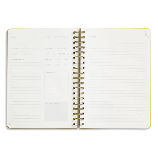 Open spiral-bound recipe journal with guided templates by Hanging Fruits, with blank lines to record ingredients and instructions.