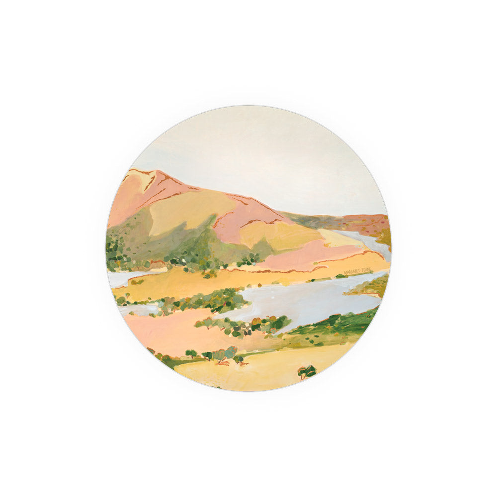Round decorative coaster by Margaret Jeane featuring an impressionistic landscape painting.