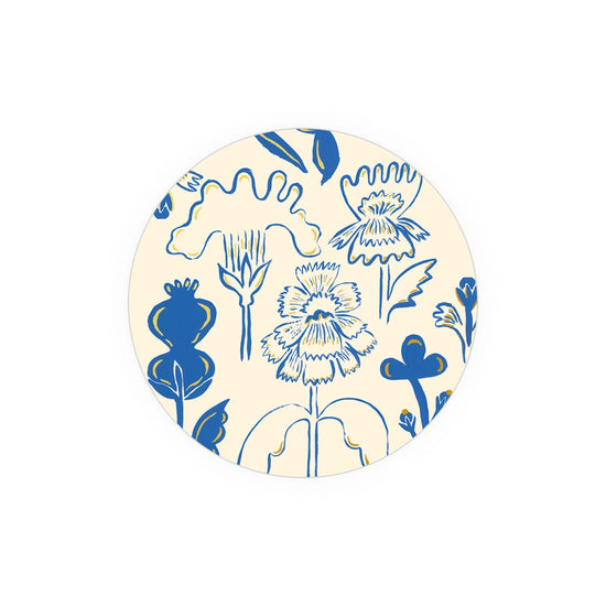 Floral patterned coasters from Seedlings, with cream background and blue and yellow botanical illustration.
