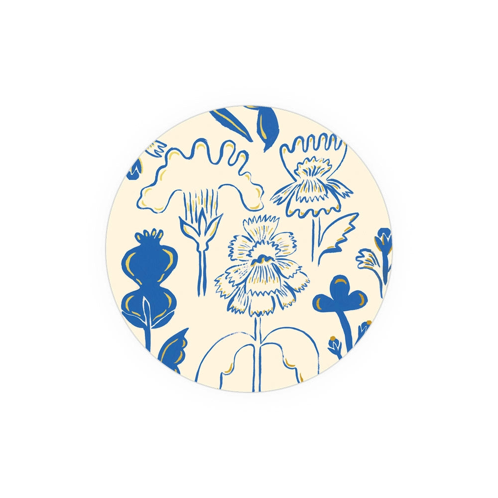 Floral patterned coasters from Seedlings, with cream background and blue and yellow botanical illustration.
