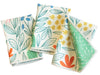 Set of three cream-colored Mighty Mini towels from RJW, patterned with colorful botanical illustrations.
