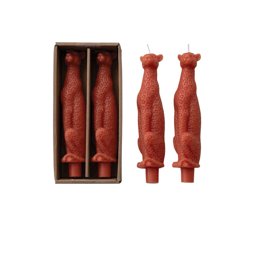 Terracotta leopard candles, set of two, with white wicks, partially in a tan cardboard box.