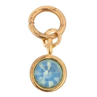 Gold-tone gemstone charm by Luca + Danni with a blue opal-like stone in a gold setting.