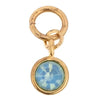 Gold-tone gemstone charm by Luca + Danni with a blue opal-like stone in a gold setting.