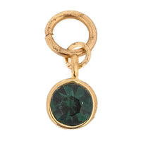 Gold tone charm with green gemstone, in a round setting.