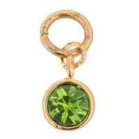 Green gemstone charm with gold-tone hardware, featuring a faceted stone.
