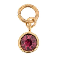 Red gemstone charm by Thea with a gold-tone loop.
