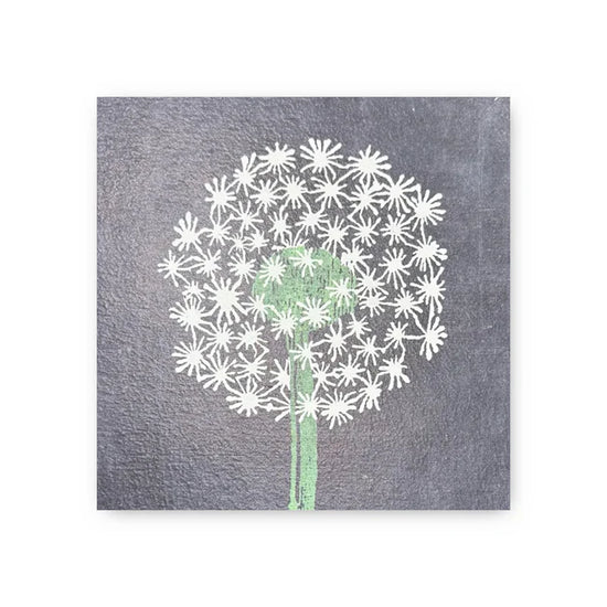 Square art tile by Art Tile Collection with a white dandelion design on a gray textured background.