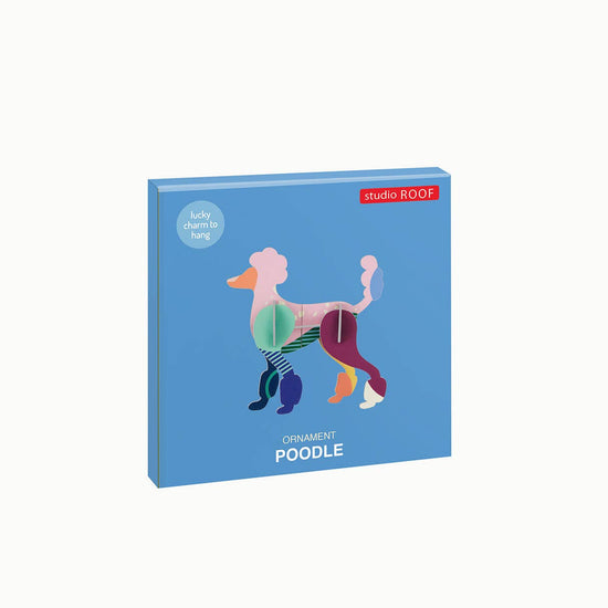 Colorful 3D poodle ornament by Studio ROOF, displayed on a blue box with text.