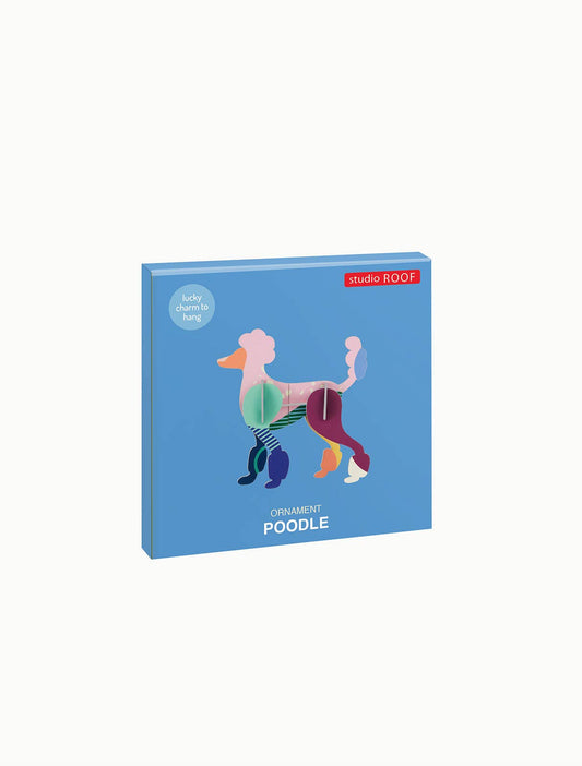 Colorful 3D poodle ornament by Studio ROOF, displayed on a blue box with text.