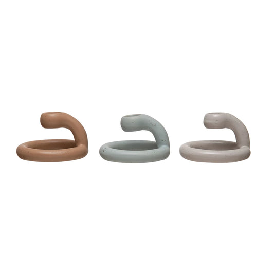 Set of ceramic swirl taper holders in brown, blue, and gray tones.