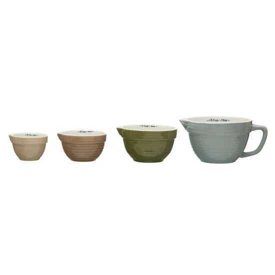 Set of four ceramic bowls in different colors on a white background