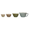 Set of four ceramic bowls in different colors on a white background