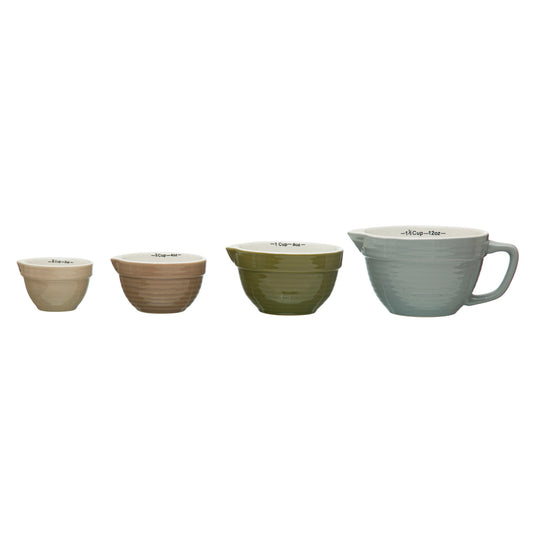 Set of four ceramic bowls in different colors on a white background