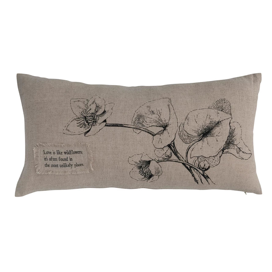 Beige lumbar pillow with wildflower design by Park Designs, featuring a fringed fabric patch with an inspirational quote.