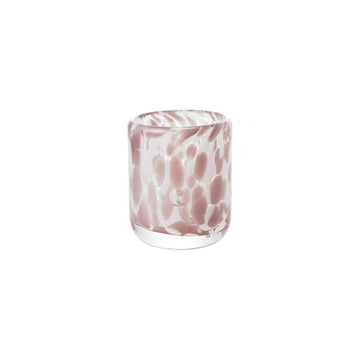 Glass with pink and white marbled pattern on a white background