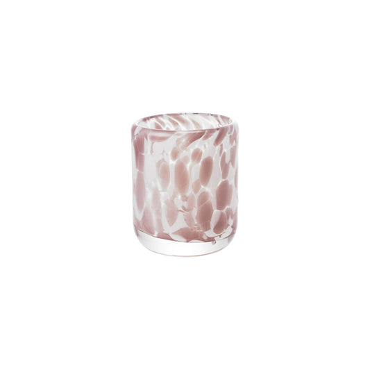 Glass with pink and white marbled pattern on a white background