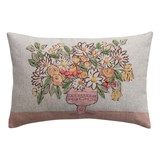 Linen blend lumbar pillow with flowers in vase, over a brown backdrop.