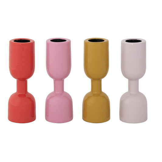 Four colorful enameled candle holders on a white background