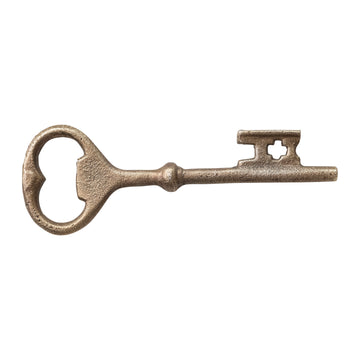Bronze key bottle opener on a white background