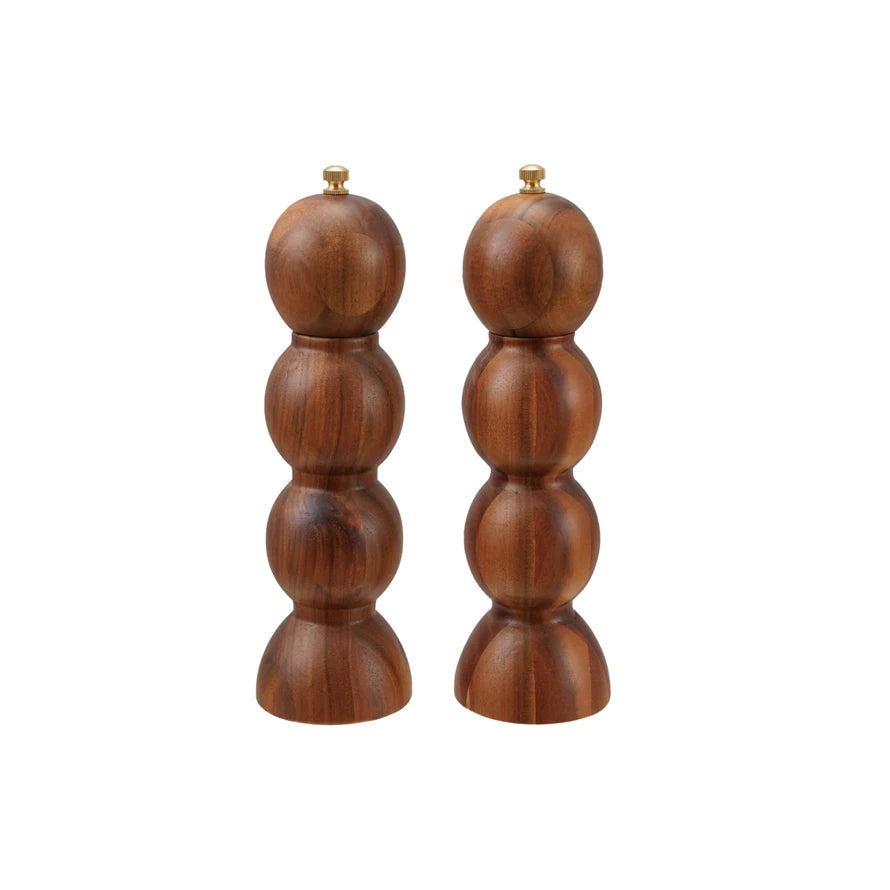 Set of two acacia wood salt and pepper mills with brass knobs by Williams Sonoma.