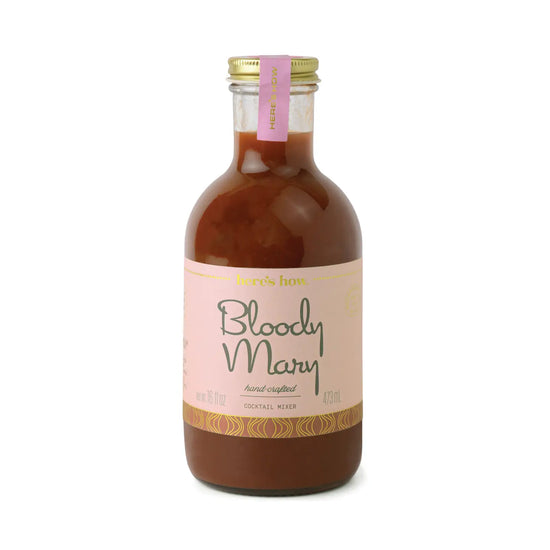 Bottle of Bloody Mary cocktail mixer from Here's How, with pink label and gold accents.
