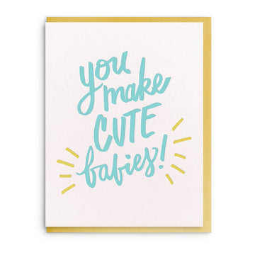 Greeting card by Wit & Whistle featuring the phrase "You Make Cute Babies!" with golden accents.