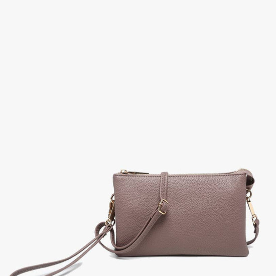 Dark mauve crossbody wristlet by unknown vendor with visible textured surface, gold hardware, and wrist strap.
