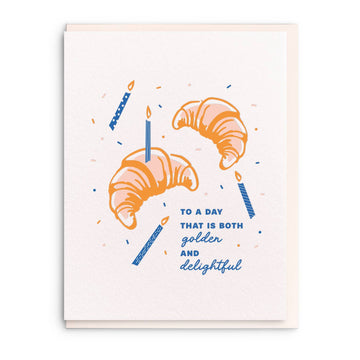 Letterpress birthday greeting card with croissant design by Sesame Letterpress, featuring blue candles and confetti details.