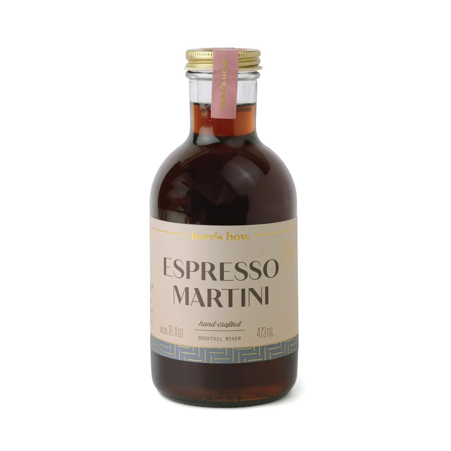 Espresso martini cocktail mixer by Here's How, in a clear glass bottle with gold lid and decorative label.