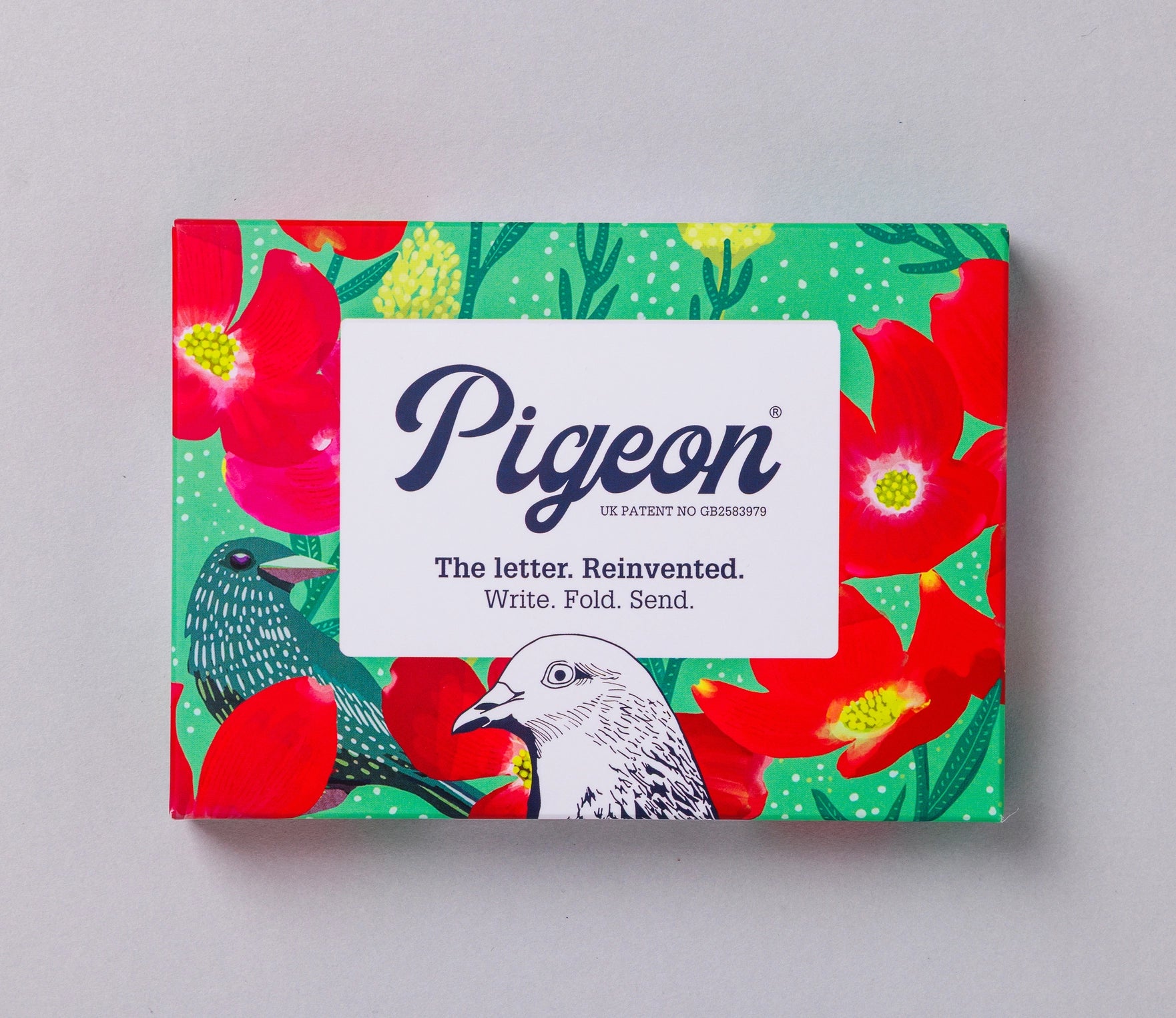 Foldable stationery set by Pigeon, featuring a vibrant floral and bird pattern on a green background.
