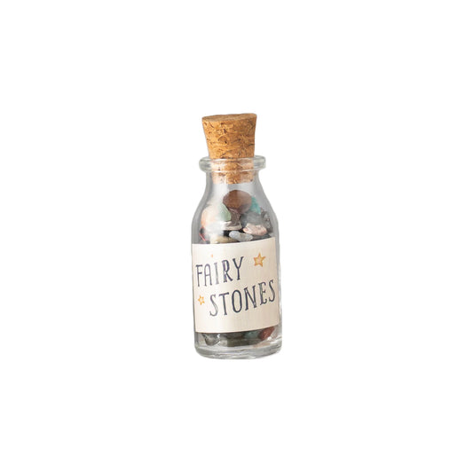 Glass bottle of fairy stones with cork stopper, with a label that says "fairy stones".