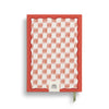 Hardcover A5 wellness journal by Papier with a red wavy trim and floral ikat checkered pattern.