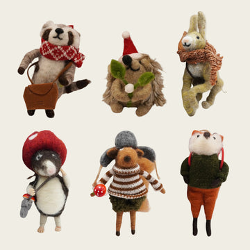 Felt woodland animal figurines with decorative details.
