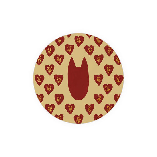 Round patterned coaster with red hearts by Seedlings, featuring gold floral designs.