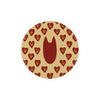 Round patterned coaster with red hearts by Seedlings, featuring gold floral designs.