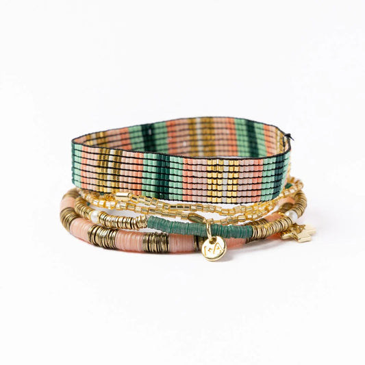 Multi-strand bracelet stack by Grace & Alex with colorful woven and beaded strands and charm details.