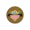 Floral printed Seedlings Coaster with pink vase and colorful blooms, set against an olive green background.