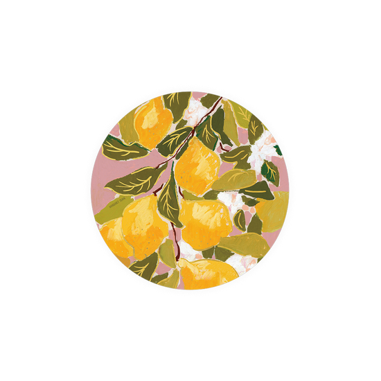 Circular decorative coaster with a painted lemon and floral design on a pink background.