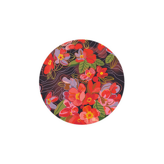 Floral patterned round coaster with red and purple blooms on a dark background.