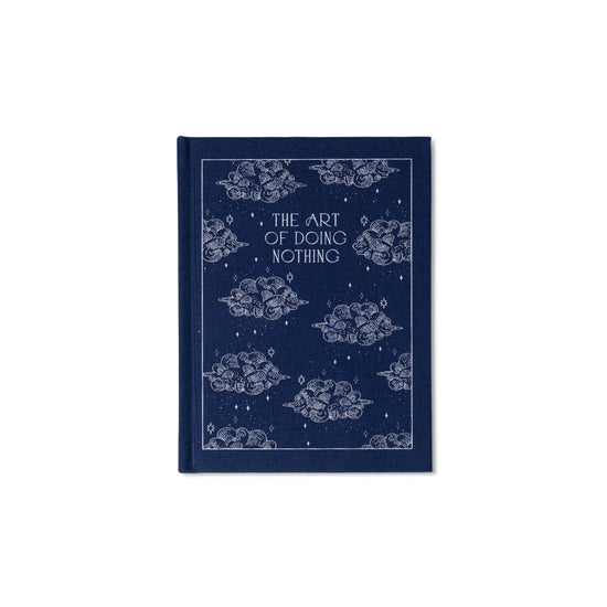 Blue bound notepad with "The Art of Doing Nothing" text, with a decorative cloud and star pattern.