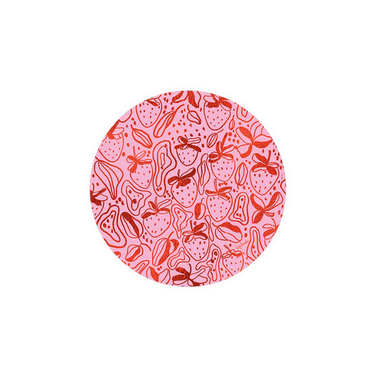 Patterned coaster with strawberries from Seedlings, with pink and red circular pattern.