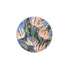 Floral pattern coaster by Margaret Jeune Jime with blue background and green stems.