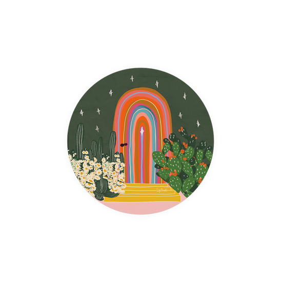 Decorative kitchen coaster with rainbow archway and desert plants.